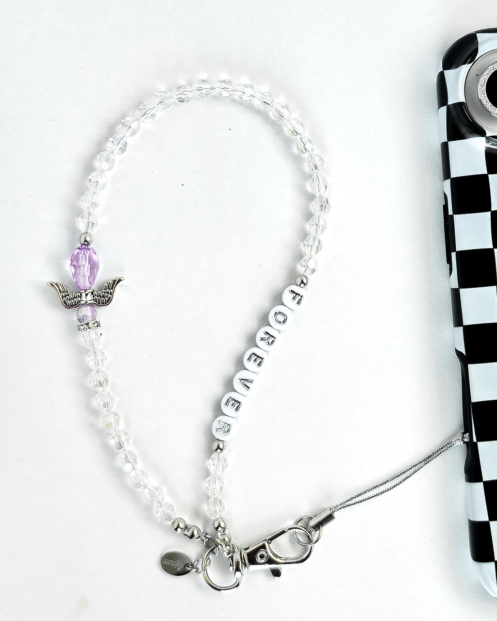 Clear, crystal beaded phone charm with lavender & silver angel bead motif and white round beads with silver letters that spell out "Forever" attached to a black and white checkered phone case