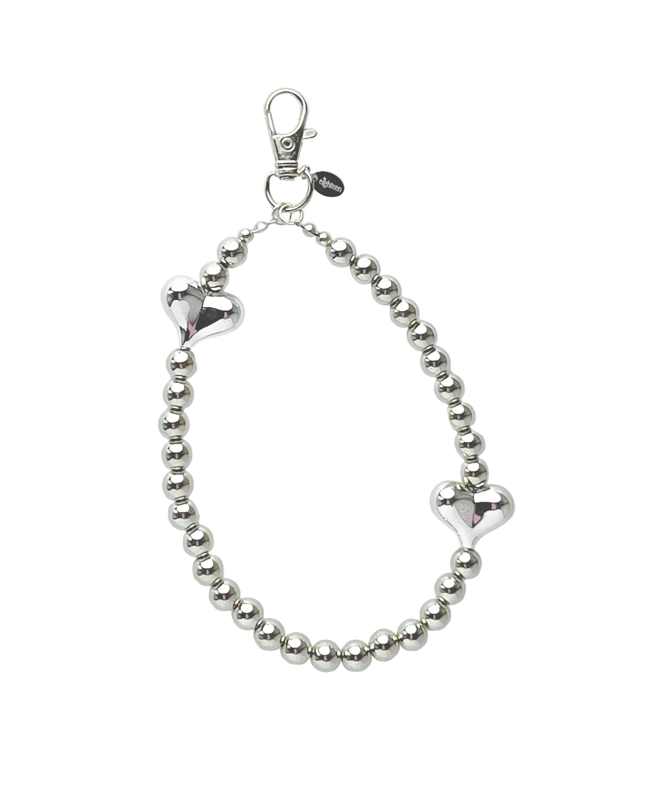 A silver beaded bracelet with two polished heart charms and a lobster clasp, displayed on a light gray background.