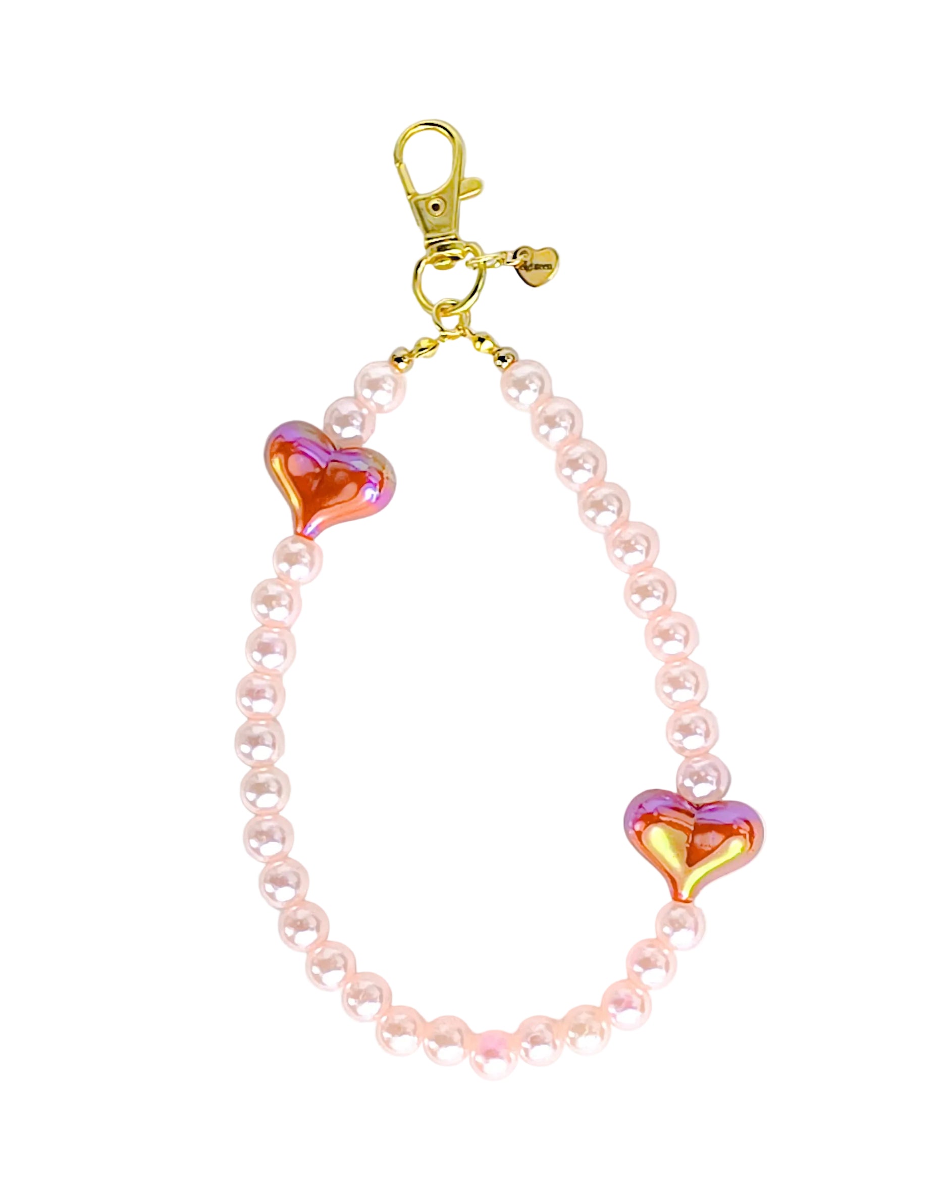 A beaded keychain or bag charm featuring light pink faux pearls, two iridescent heart-shaped beads with pink and gold reflections, and a gold clasp on a plain white background.
