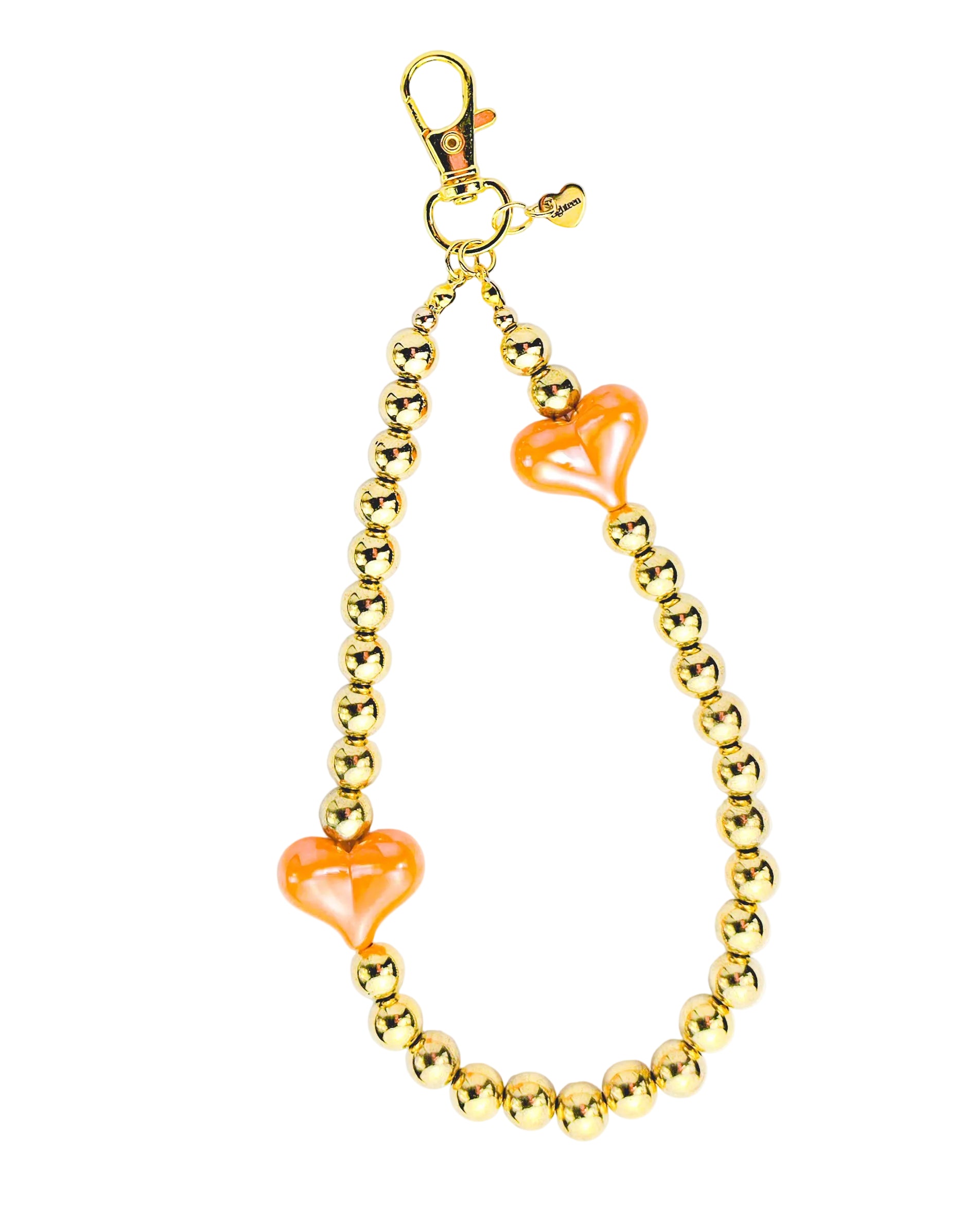 A gold-tone beaded chain accessory with two translucent orange heart-shaped beads, featuring a lobster clasp at the top, shown on a plain white background.