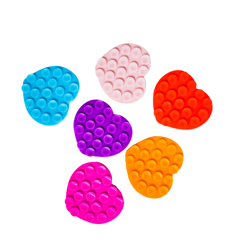 Six heart-shaped suction grips in assorted bright colors, including aqua blue, pale pink, red, purple, orange, and magenta, arranged on a plain white background.
