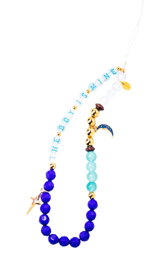 Necklace with blue beads and gold accents on a white background